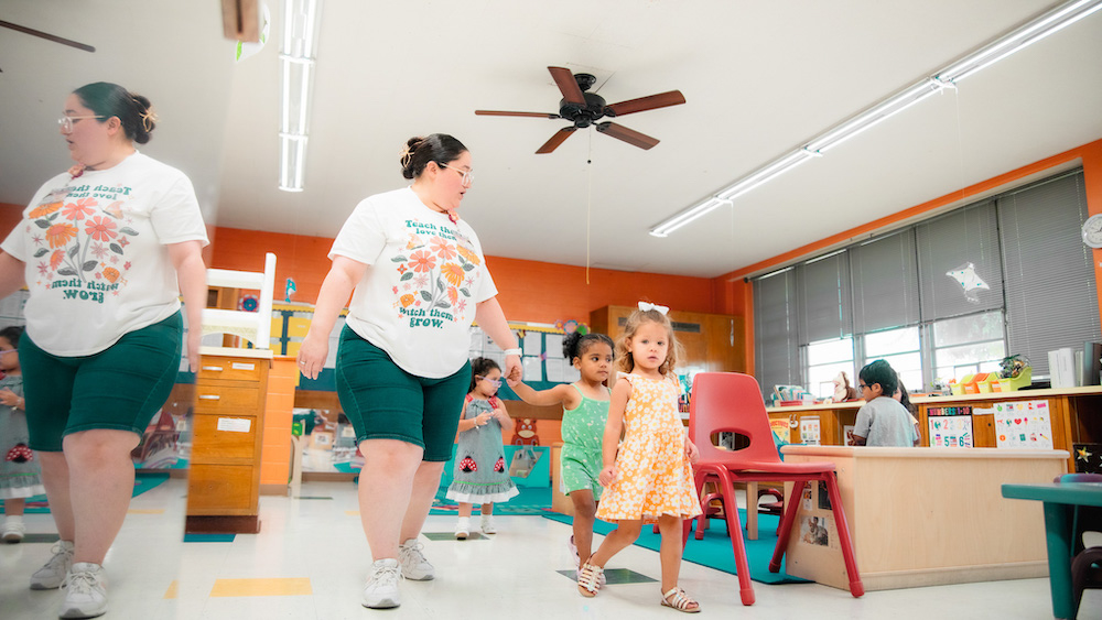 A colorful room with an early childcare educator and children