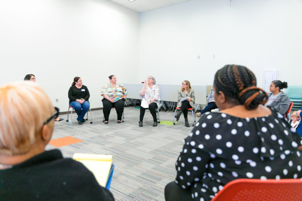 An early learning shared services alliance workshop with child care providers seated in a circle